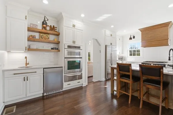 a view of a dining room with furniture a chandelier and wooden floor