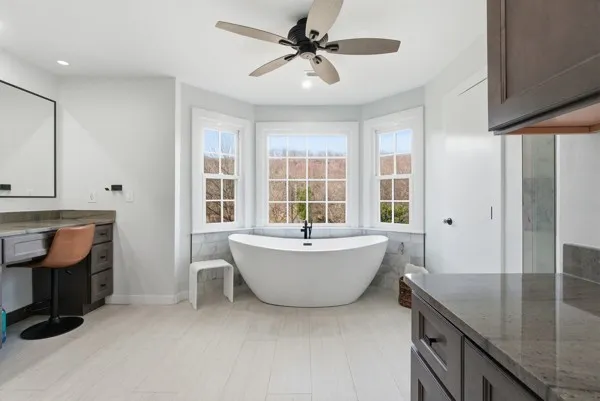 a view of a workspace with furniture and a window