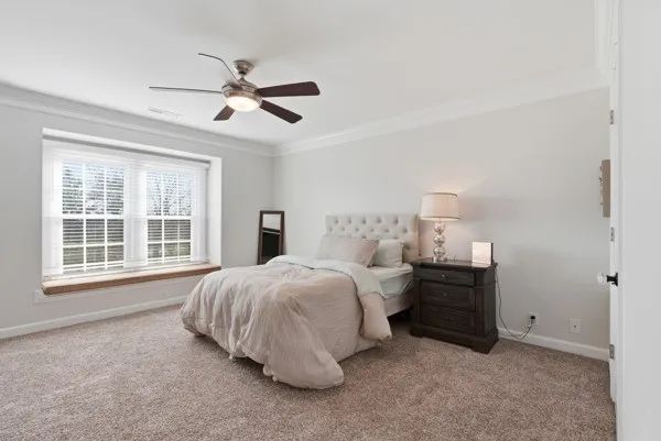 a view of a white house with a yard and sitting area