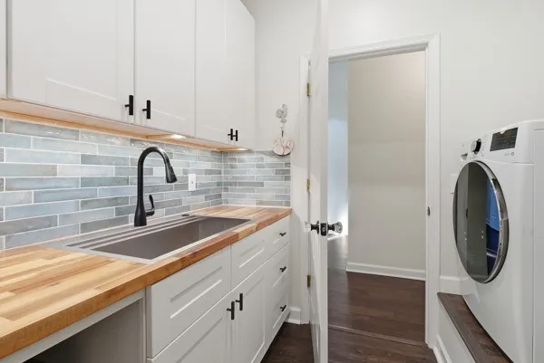 an aerial view of residential house with outdoor space and trees all around