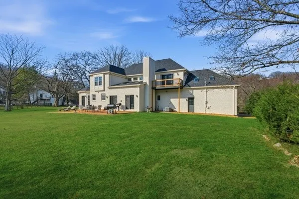 an aerial view of a house with a yard and lake view