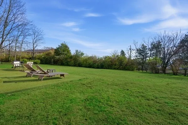 a view of a house with backyard and sitting area