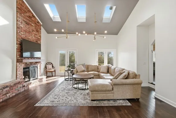 a living room with furniture and a wooden floor