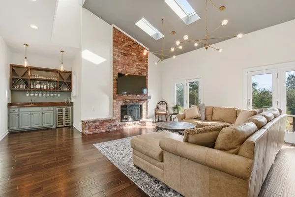a living room with furniture a fireplace and a flat screen tv