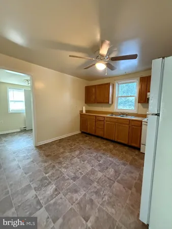 a view of an empty room with window and cabinet