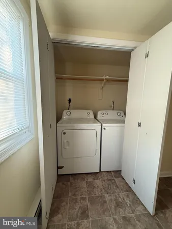 a bathroom with a sink a toilet a mirror and shower