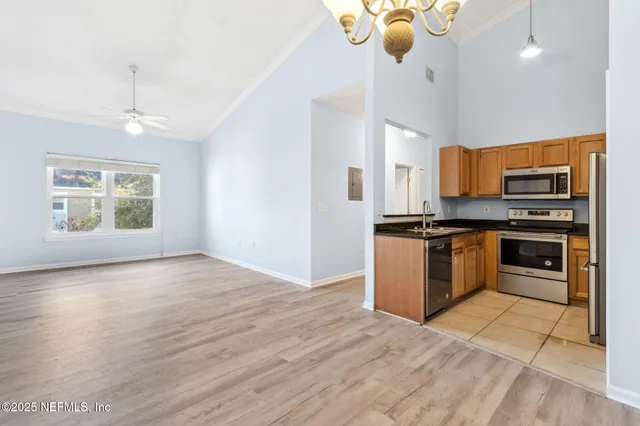 a kitchen with stainless steel appliances granite countertop a refrigerator and a stove top oven