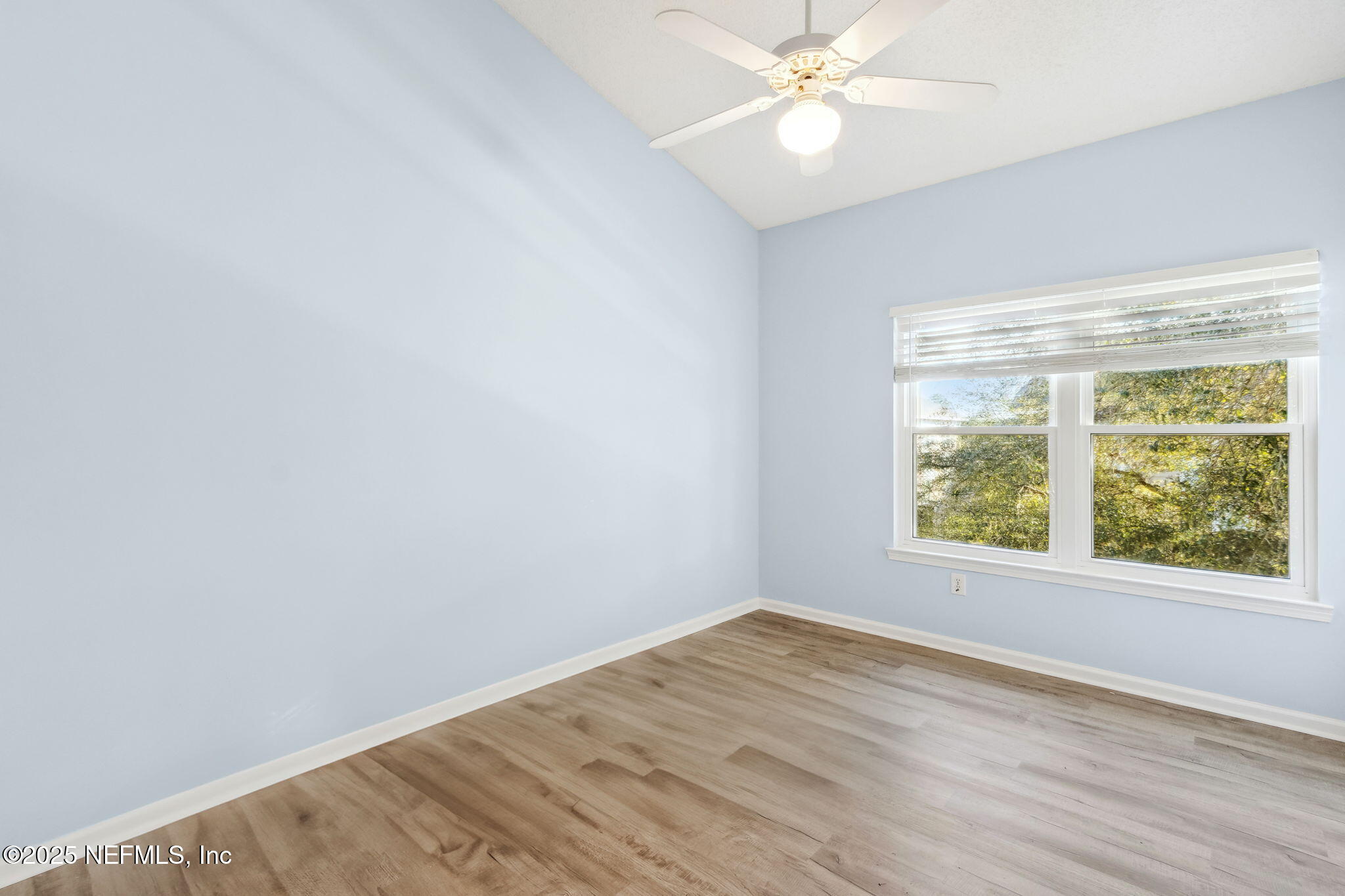 1601 Nectarine Street, Unit F6 Fernandina Beach, FL 32034 - Photo 25 of 57 an empty room with a window and wooden floor