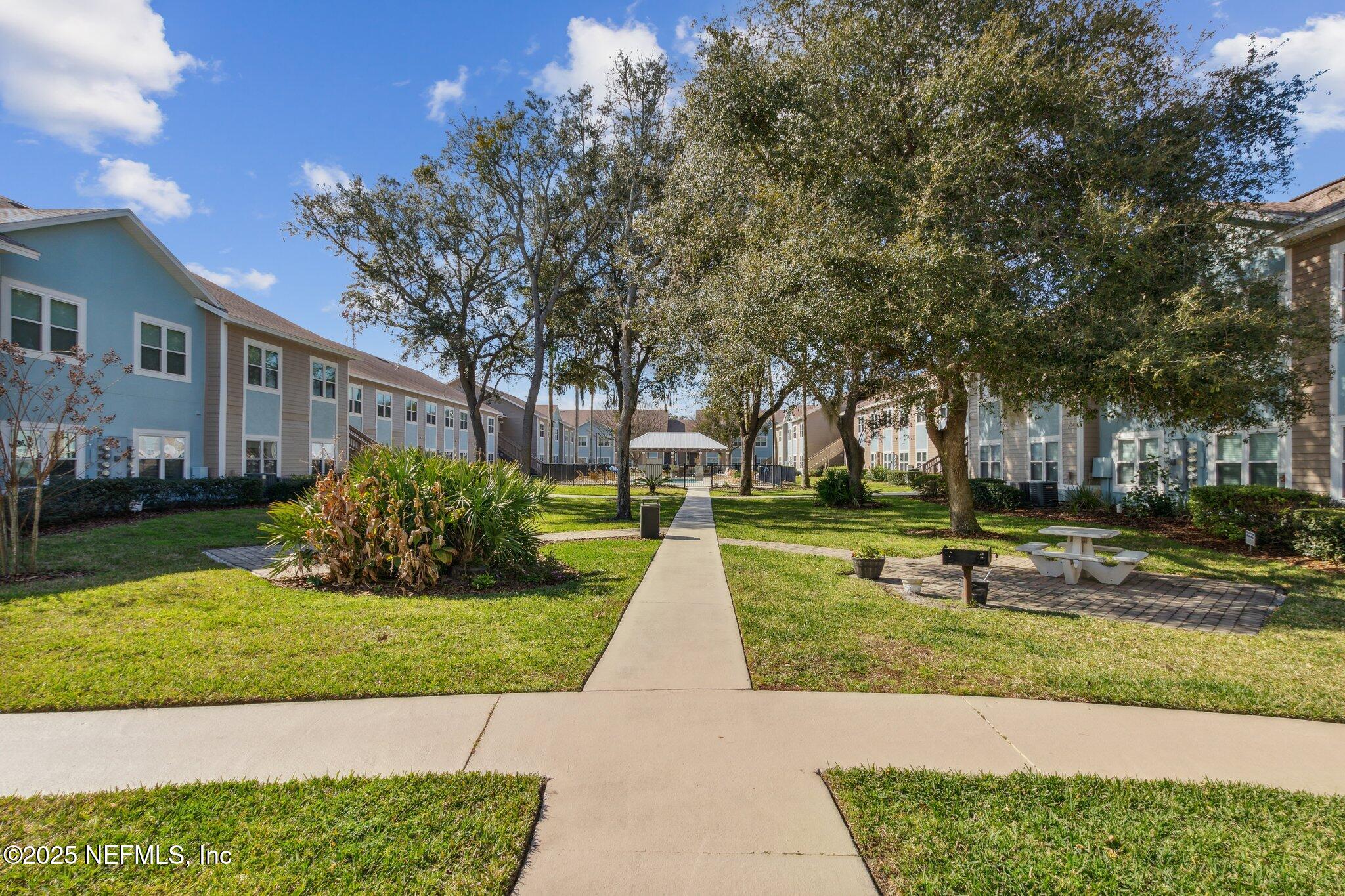1601 Nectarine Street, Unit F6 Fernandina Beach, FL 32034 - Photo 39 of 57 a view of a house with garden and trees
