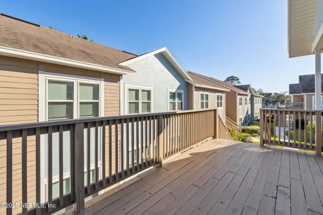 a view of a house with deck and wooden floor