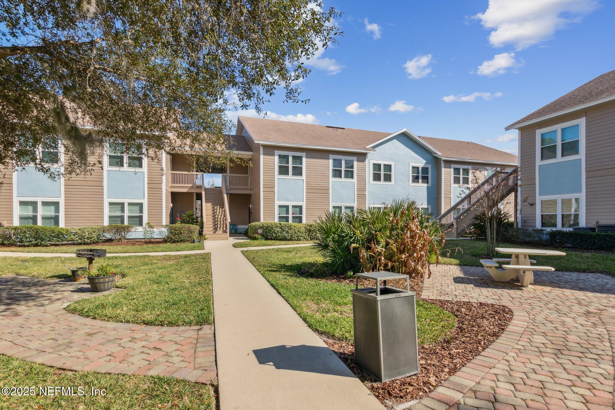 1601 Nectarine Street, Unit F6 Fernandina Beach, FL 32034 - Photo 41 of 57 a front view of a house with a yard