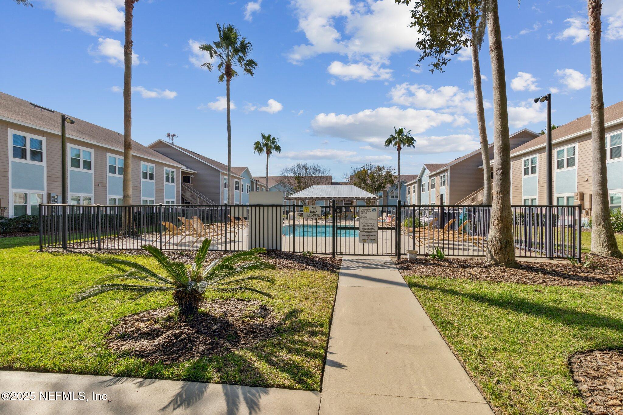 1601 Nectarine Street, Unit F6 Fernandina Beach, FL 32034 - Photo 44 of 57 a view of a swimming pool with a lounge chairs