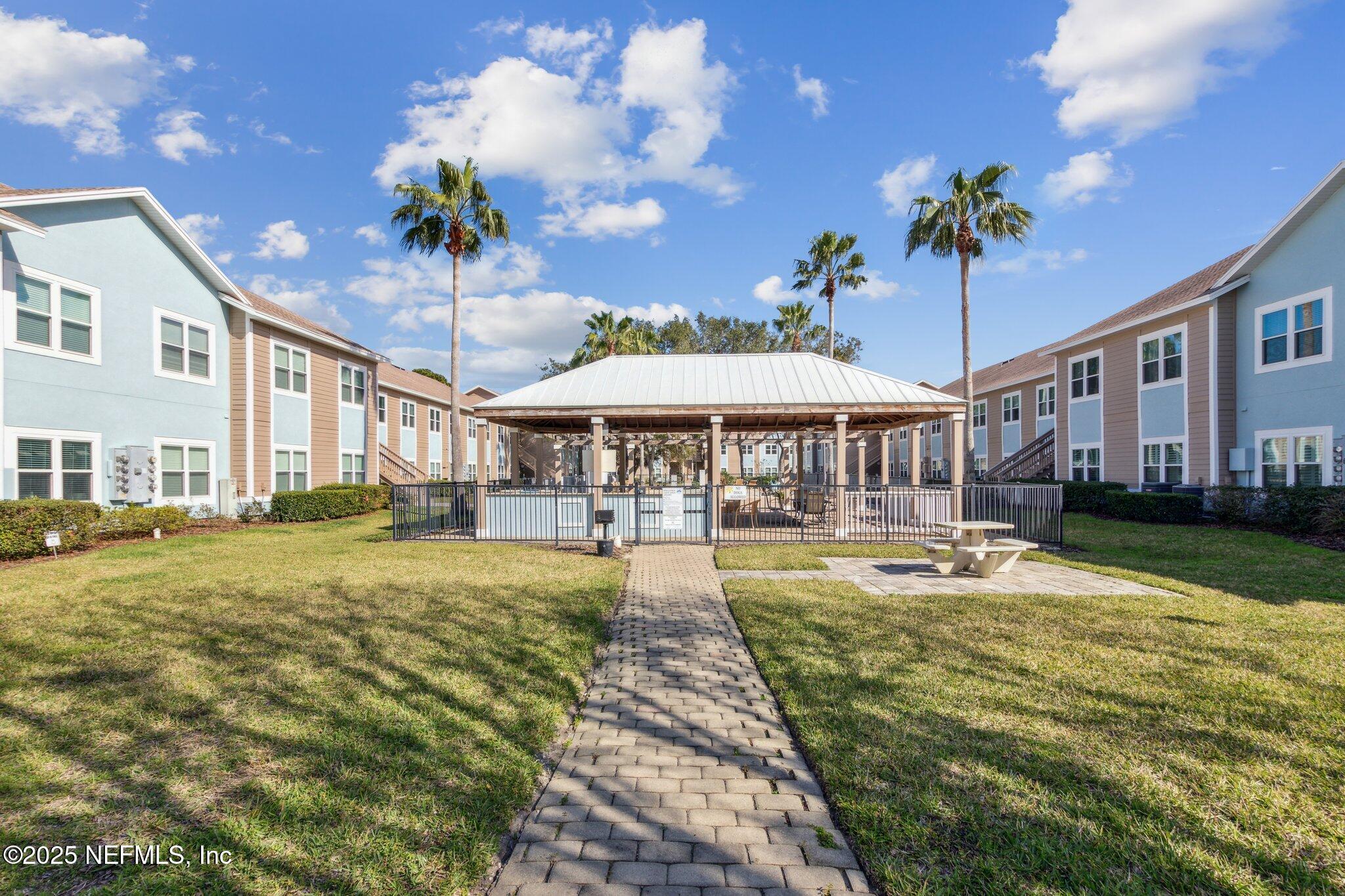 1601 Nectarine Street, Unit F6 Fernandina Beach, FL 32034 - Photo 47 of 57 a swimming pool view with a seating space and a garden