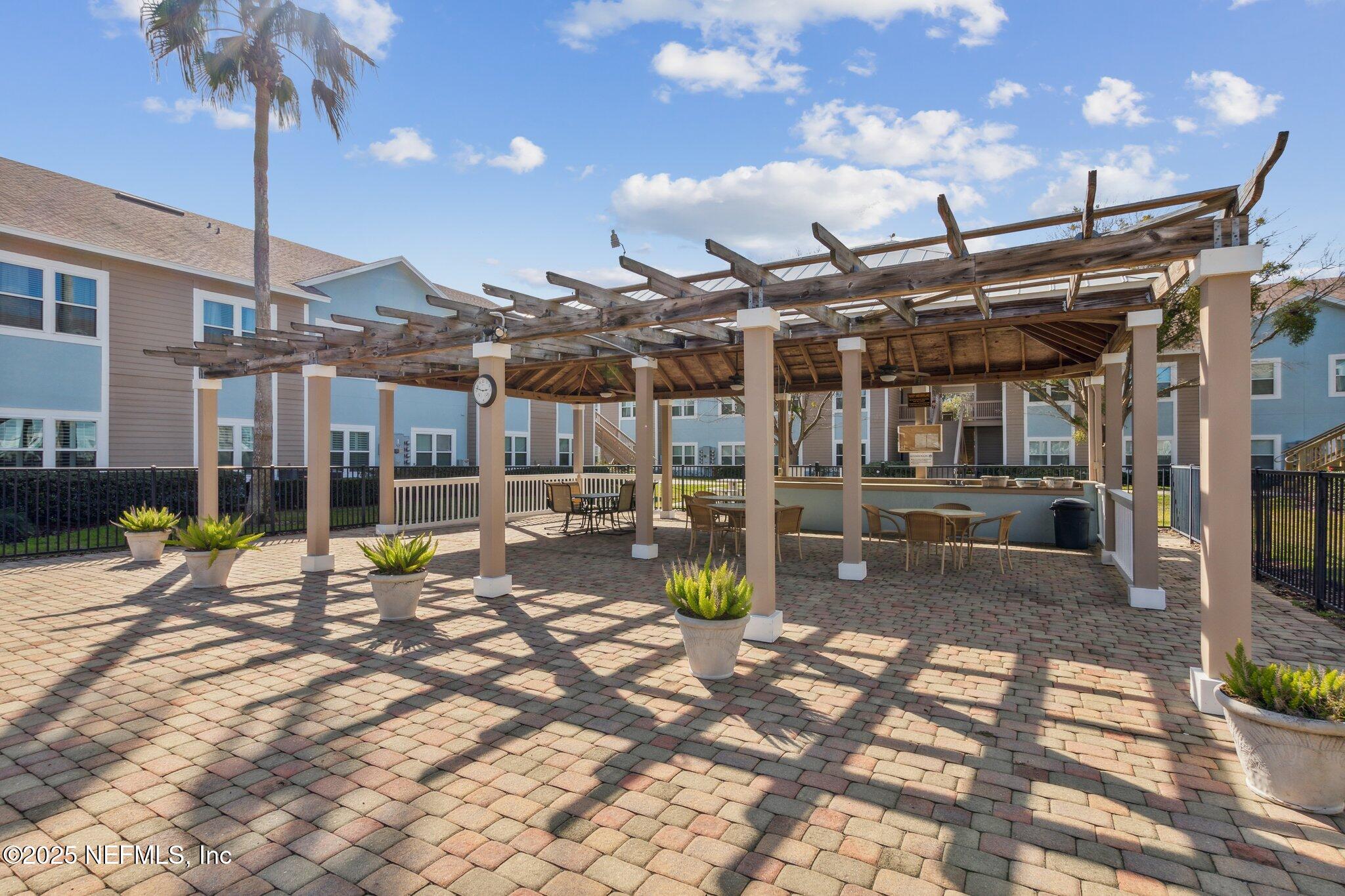 1601 Nectarine Street, Unit F6 Fernandina Beach, FL 32034 - Photo 49 of 57 a view of a porch with furniture and a fire pit