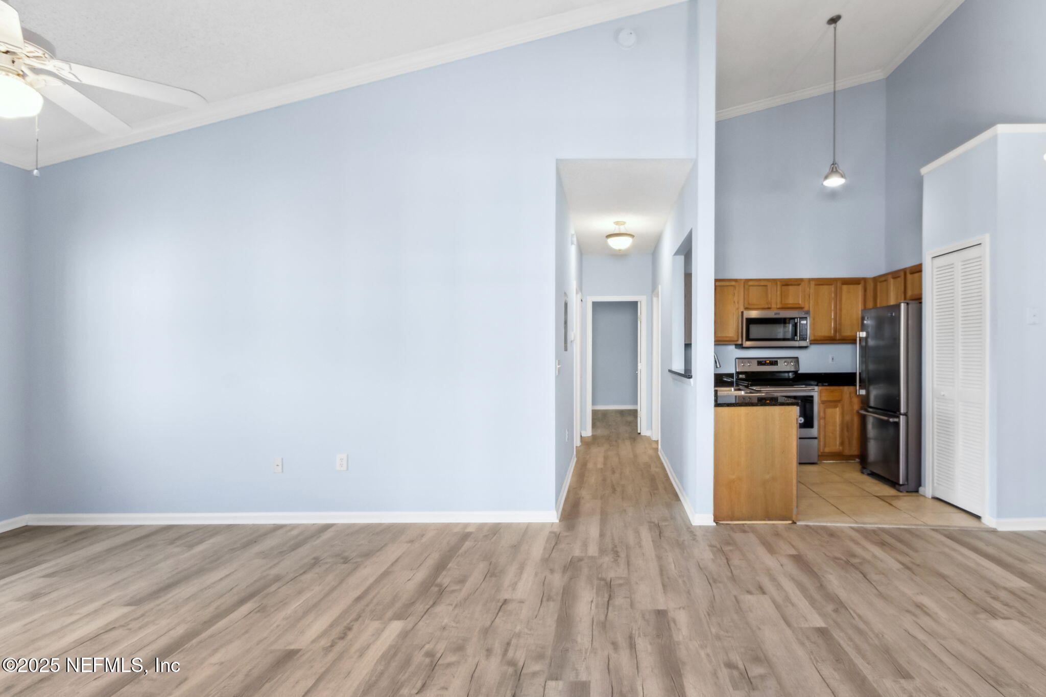 1601 Nectarine Street, Unit F6 Fernandina Beach, FL 32034 - Photo 7 of 57 a view of kitchen with kitchen island wooden floor stainless steel appliances and cabinets