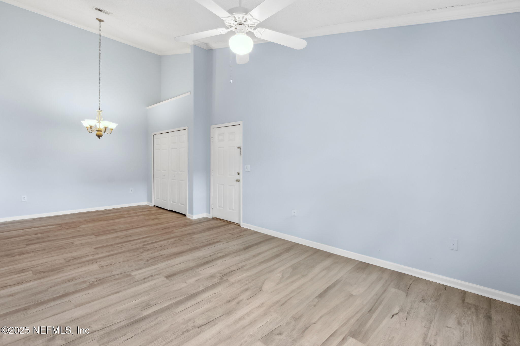 1601 Nectarine Street, Unit F6 Fernandina Beach, FL 32034 - Photo 9 of 57 a view of an empty room with wooden floor and a ceiling fan