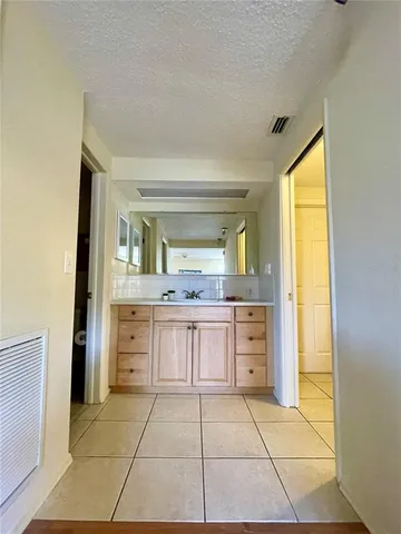 a kitchen with white cabinets and appliances