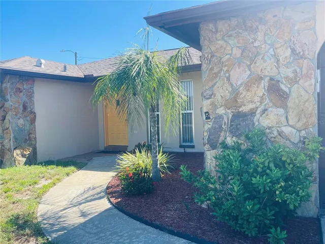 a couple of potted plants in front of door