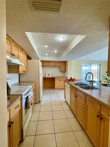 a large kitchen with stainless steel appliances granite countertop a sink and cabinets