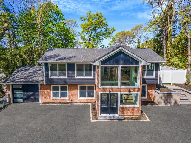 a front view of a house with a garden