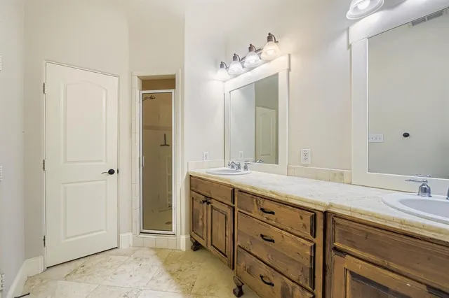 a spacious bathroom with a double vanity sink mirror and