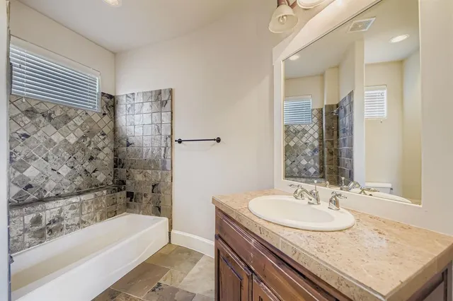 a bathroom with a tub sink and mirror