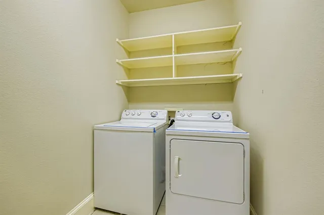 a view of storage and utility room with washer and dryer