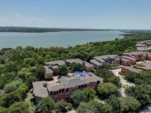 an aerial view of a house with a lake view