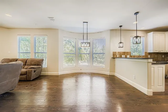 a living room with furniture window and wooden floor