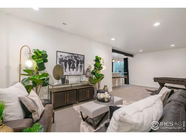 a living room with furniture flowerpot and a chandelier