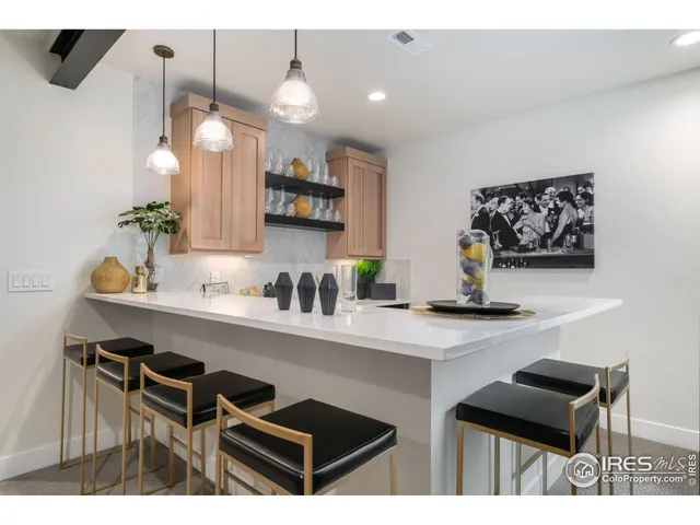 a view of kitchen island cabinets and chairs