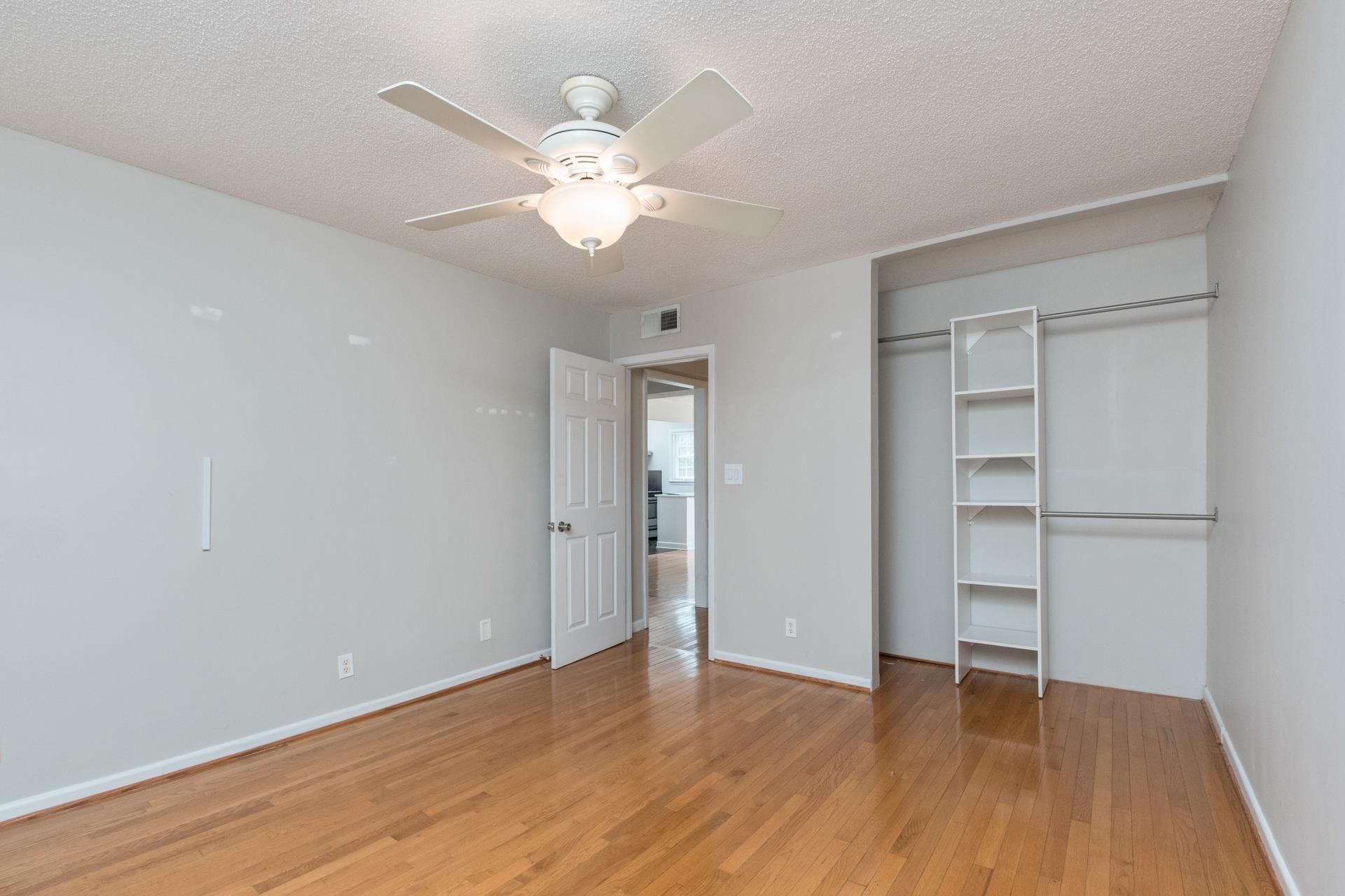 2527 Hydraulic Road, Unit 17 Charlottesville, VA 22901 - Photo 6 of 35 an empty room with wooden floor closet and windows