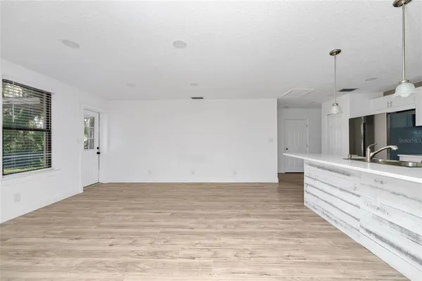 a view of a bedroom with a sink and mirror