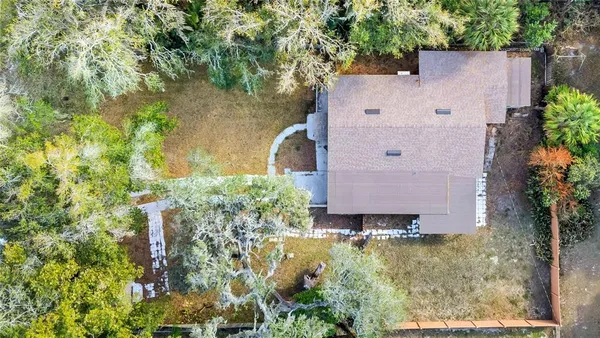 an aerial view of a house with a yard