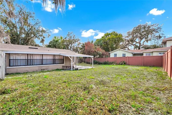 a view of a house with a backyard