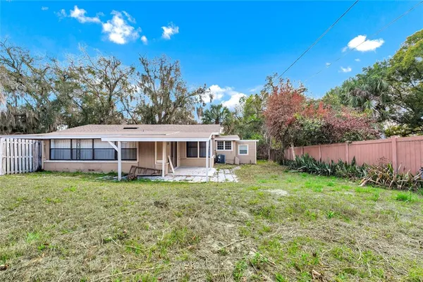 a view of a house with a yard balcony and sitting area