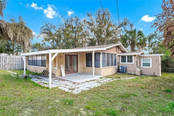 a house that has a tree in front of a house