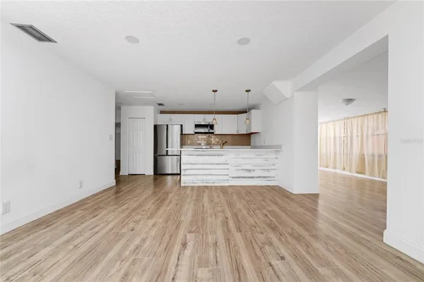 a view of a room with wooden floor