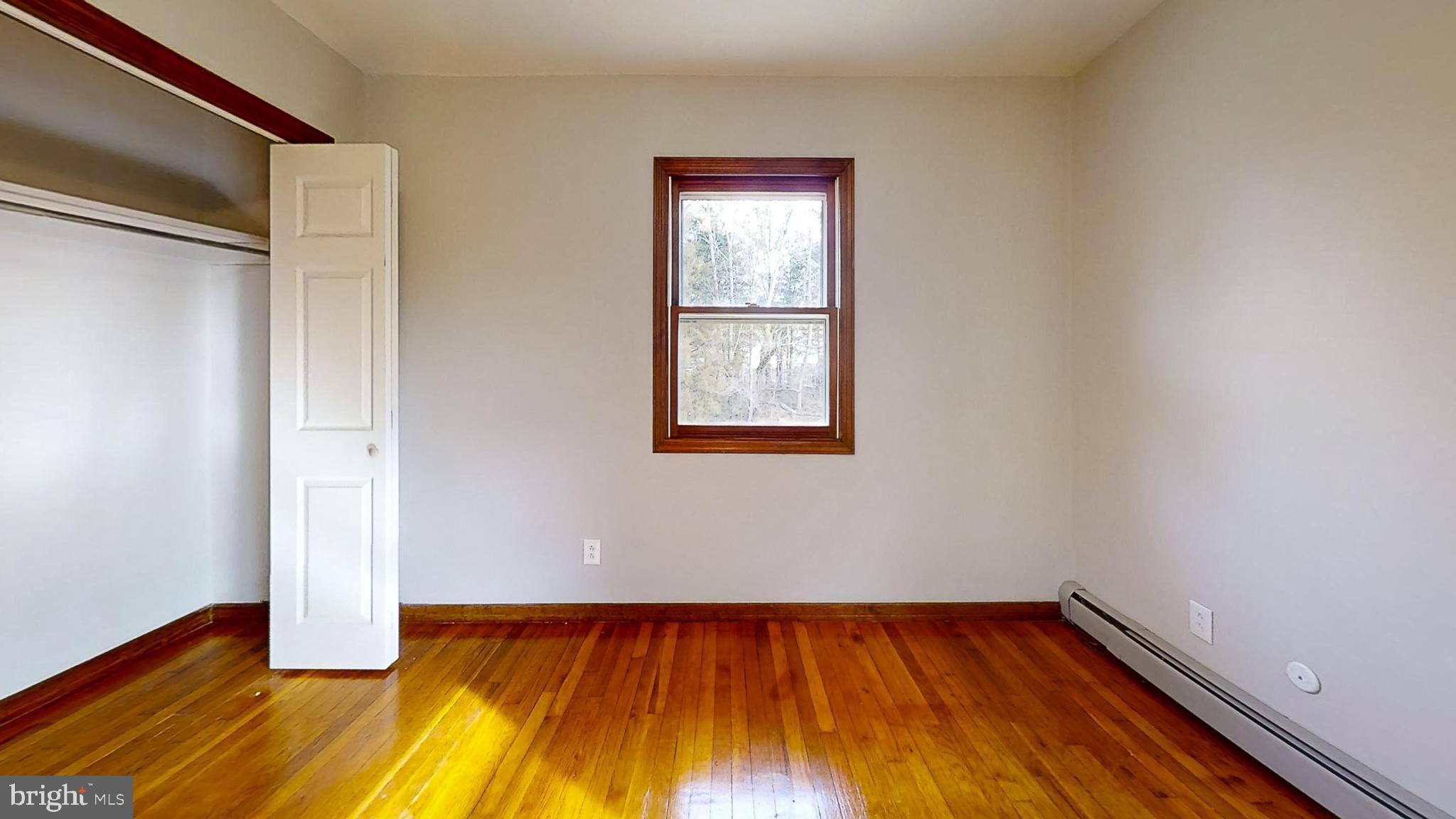 653 Buckshutem Road Bridgeton, NJ 08302 - Photo 17 of 29 a view of an empty room with wooden floor and a window