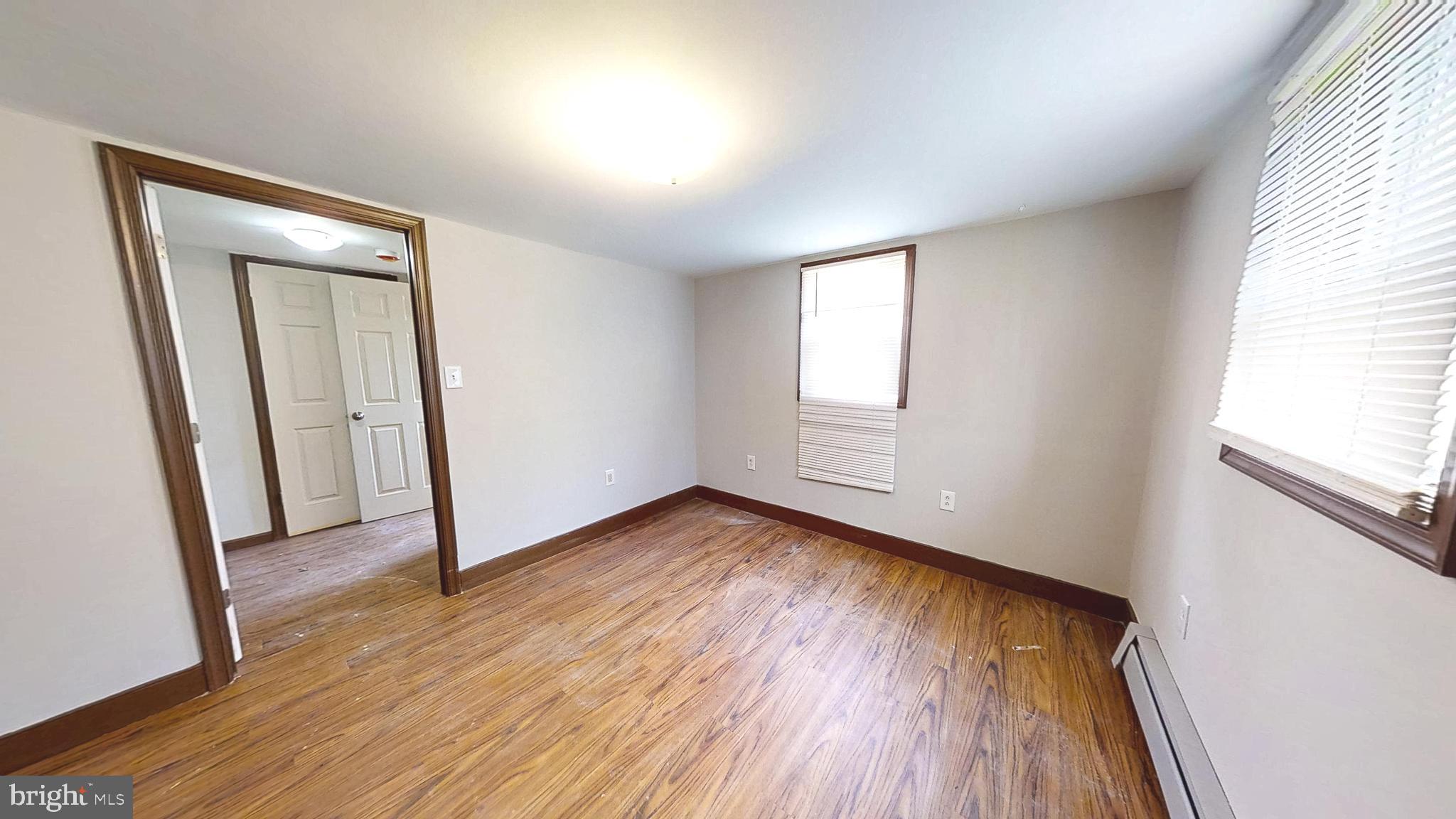 653 Buckshutem Road Bridgeton, NJ 08302 - Photo 24 of 29 an empty room with wooden floor and windows