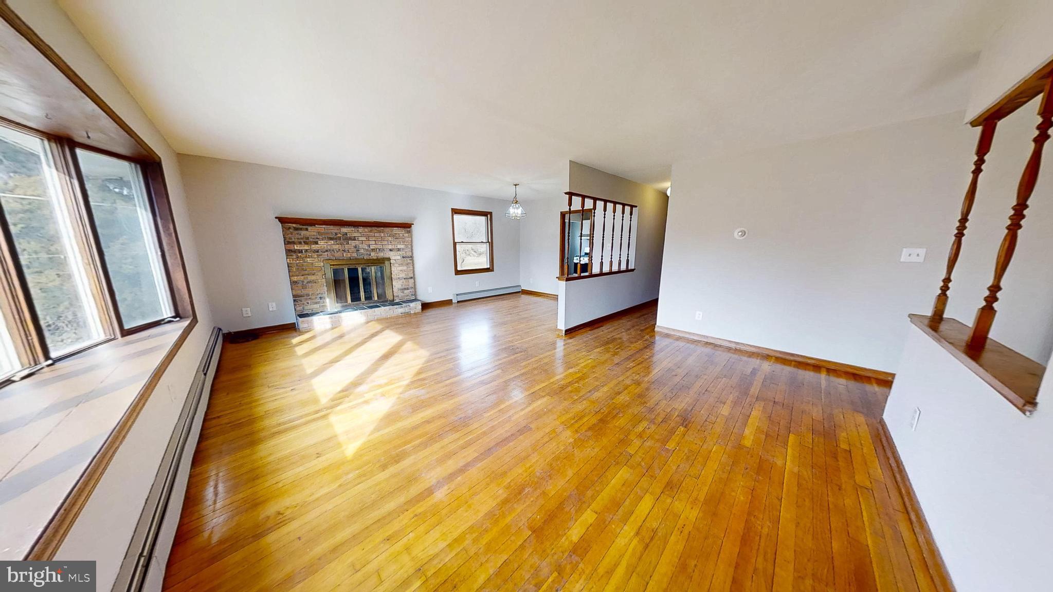 653 Buckshutem Road Bridgeton, NJ 08302 - Photo 5 of 29 a view of an empty room with wooden floor and a window
