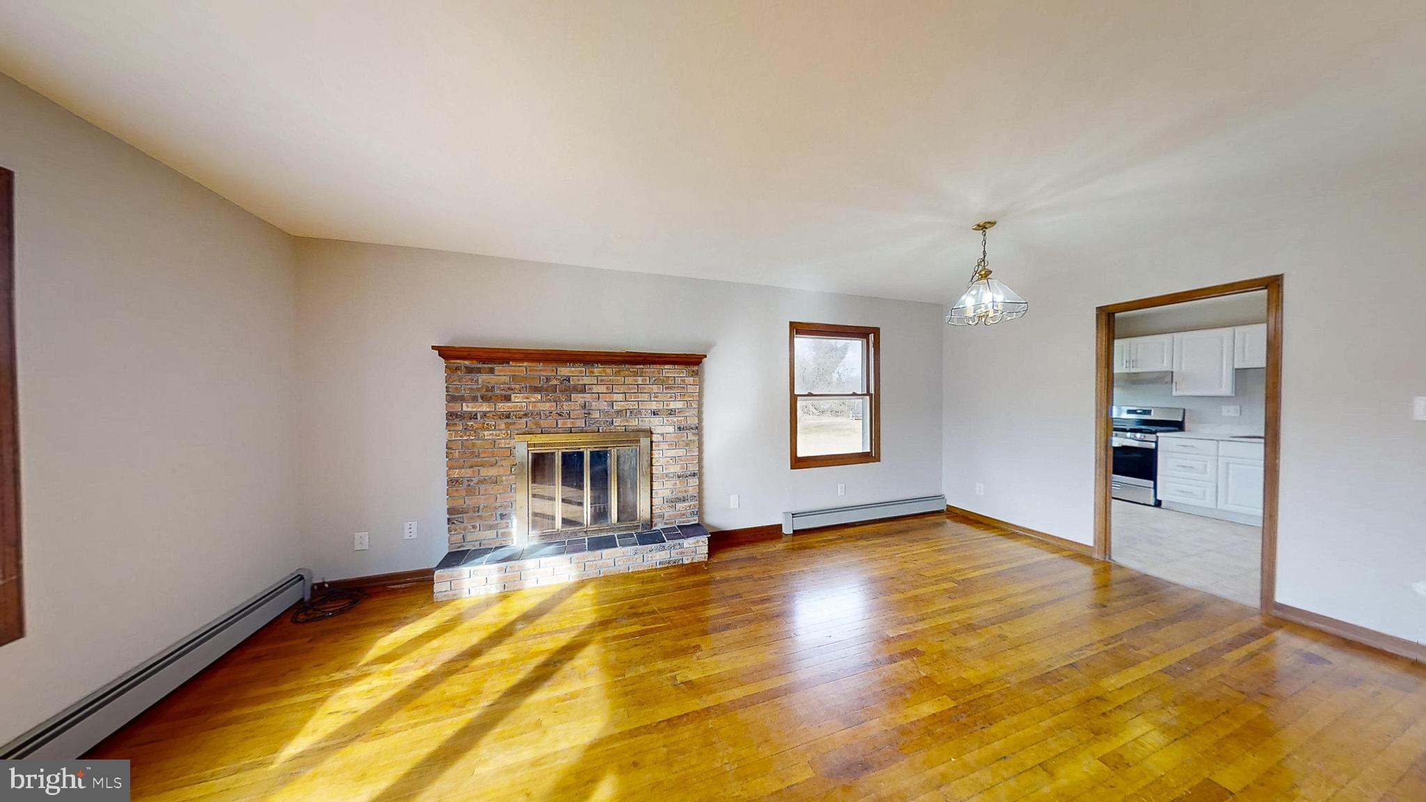 653 Buckshutem Road Bridgeton, NJ 08302 - Photo 9 of 29 a view of an empty room with window and wooden floor
