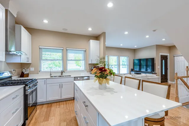 a kitchen with a sink a stove and cabinets