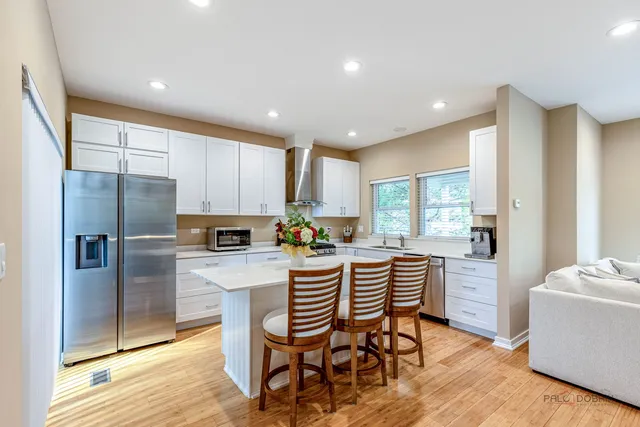 a kitchen with a table chairs refrigerator and microwave