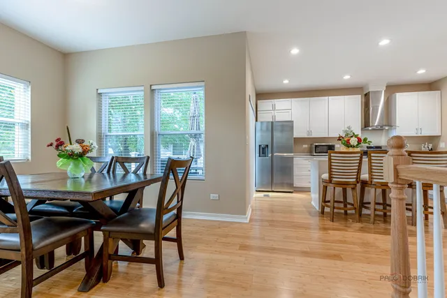 a dining room with furniture and wooden floor