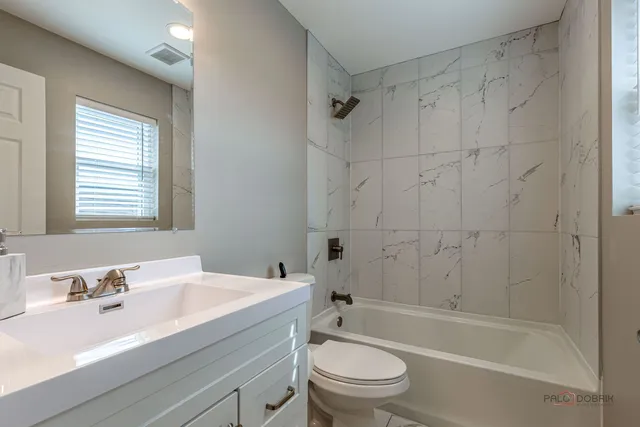 a bathroom with a sink toilet a mirror and shower