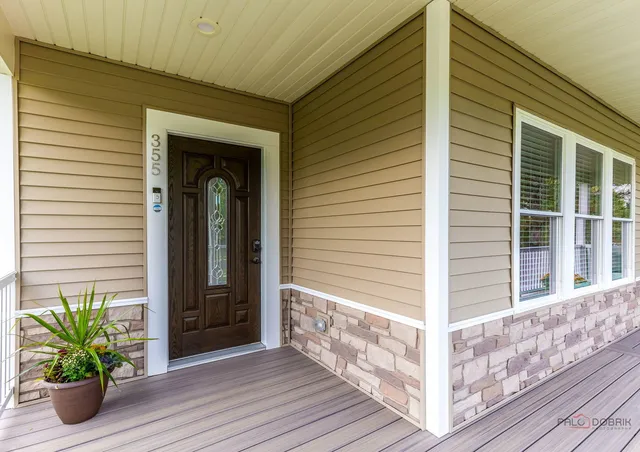 a view of a house with potted plants