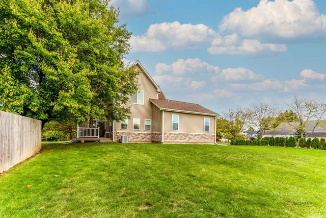 a view of a house with a big yard and large trees