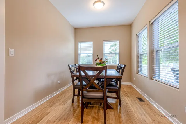 a view of a dining room with furniture and wooden floor
