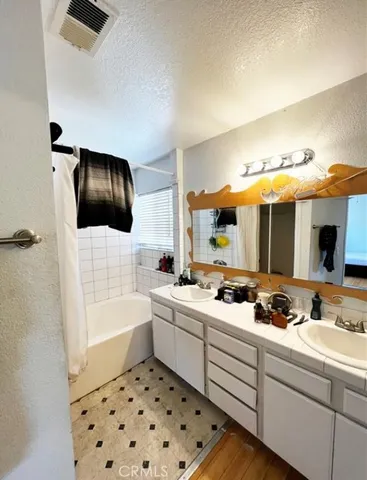 a bathroom with a sink a toilet a shower and bathtub